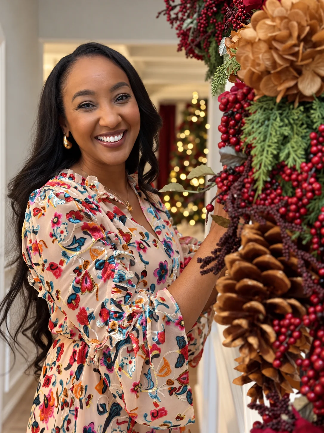 Shanda Brooks arranging a decorated holiday garland in a festive home